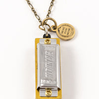 Genuine Hohner harmonica necklace with brass charm with text "Here for Now"