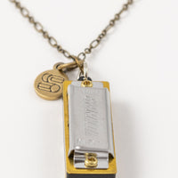 Genuine Hohner harmonica necklace with brass charm with Sound as Ever logo