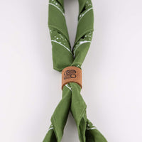 Leather bandana slide in brown genuine leather with stamped Sound As Ever "S" logo that ties closed a green bandana