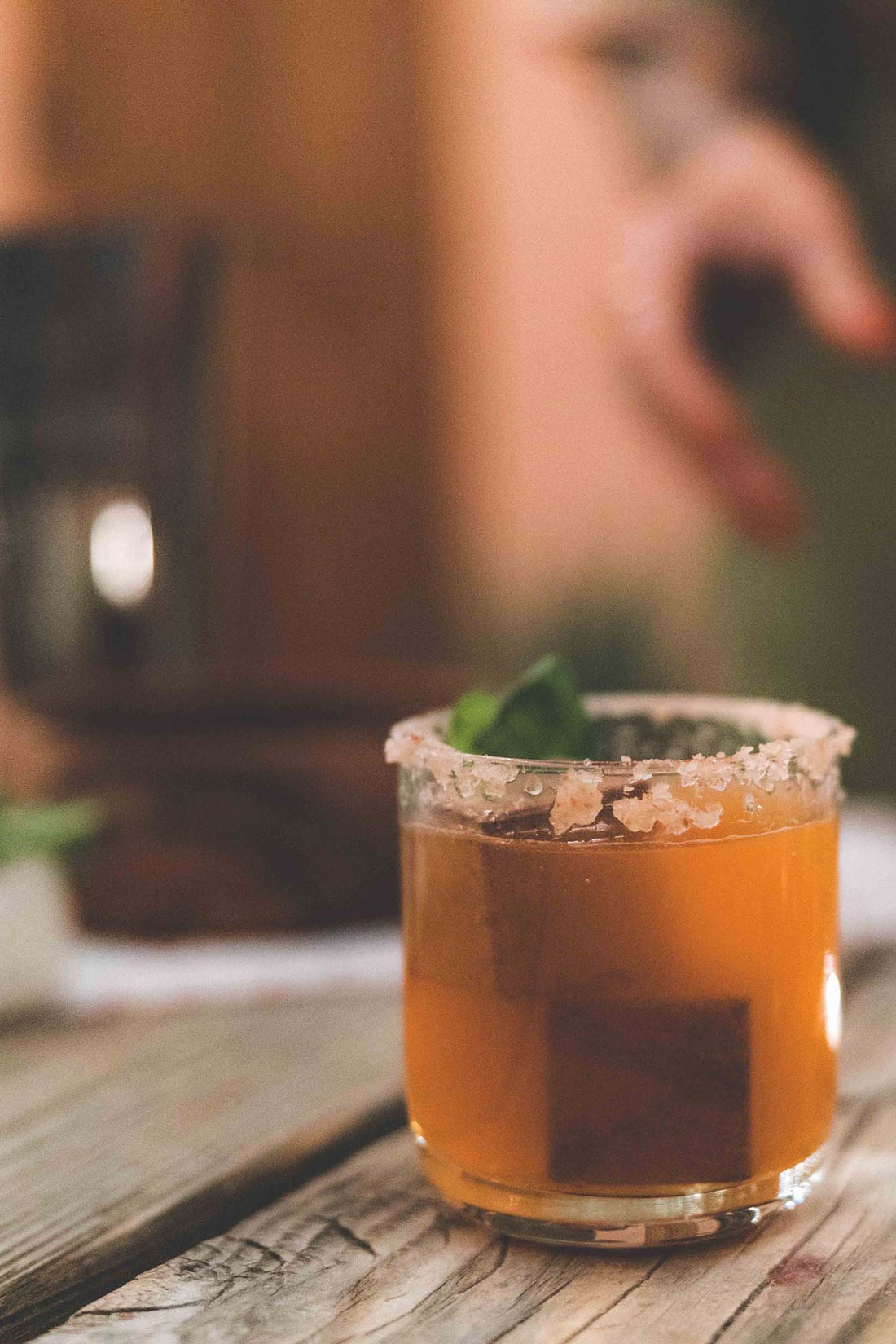 Whiskey stone set with quartz cube whiskey stones inside a mixed drink in a whiskey glass