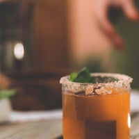 Whiskey stone set with quartz cube whiskey stones inside a mixed drink in a whiskey glass