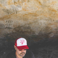 Map wearing white and red 70s trucker hat with text "God Bless Gram Parsons"