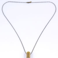 Bullet quartz necklace with brass bullet casing over clear quartz with an antique brass chain and clasp