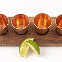 Sound as Ever wooden flight board with copper shot glass and limes
