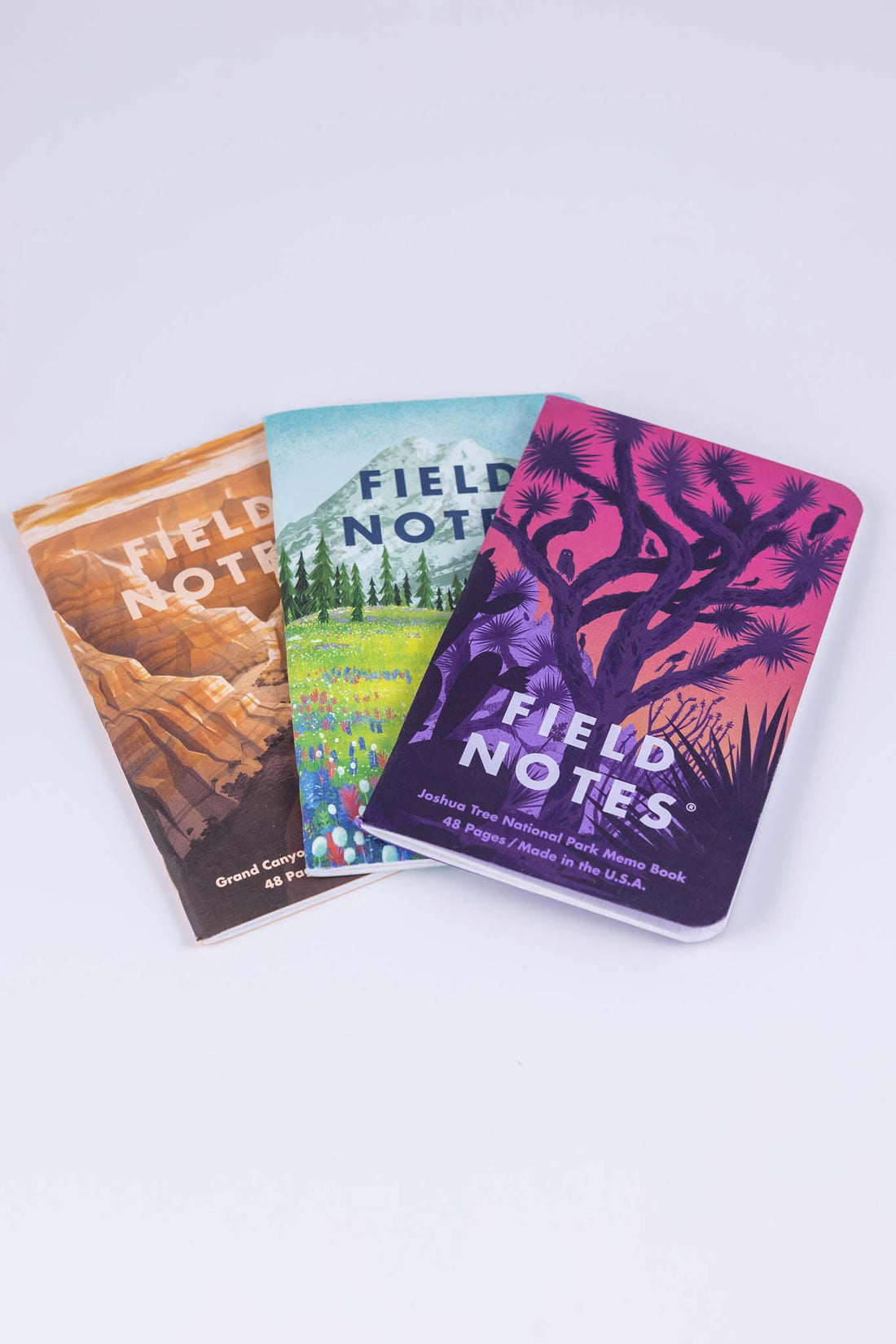 Field notes national parks pack of 3 featuring gorgeous cover illustrations depicting the Grand Canyon National Park, Mount Rainier National Park and, Joshua Tree National Park