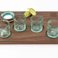 Landscape orientation view of Marfa Nights light blue Hand Blown Shot Glasses and dark wood flight tray with indentations for glasses