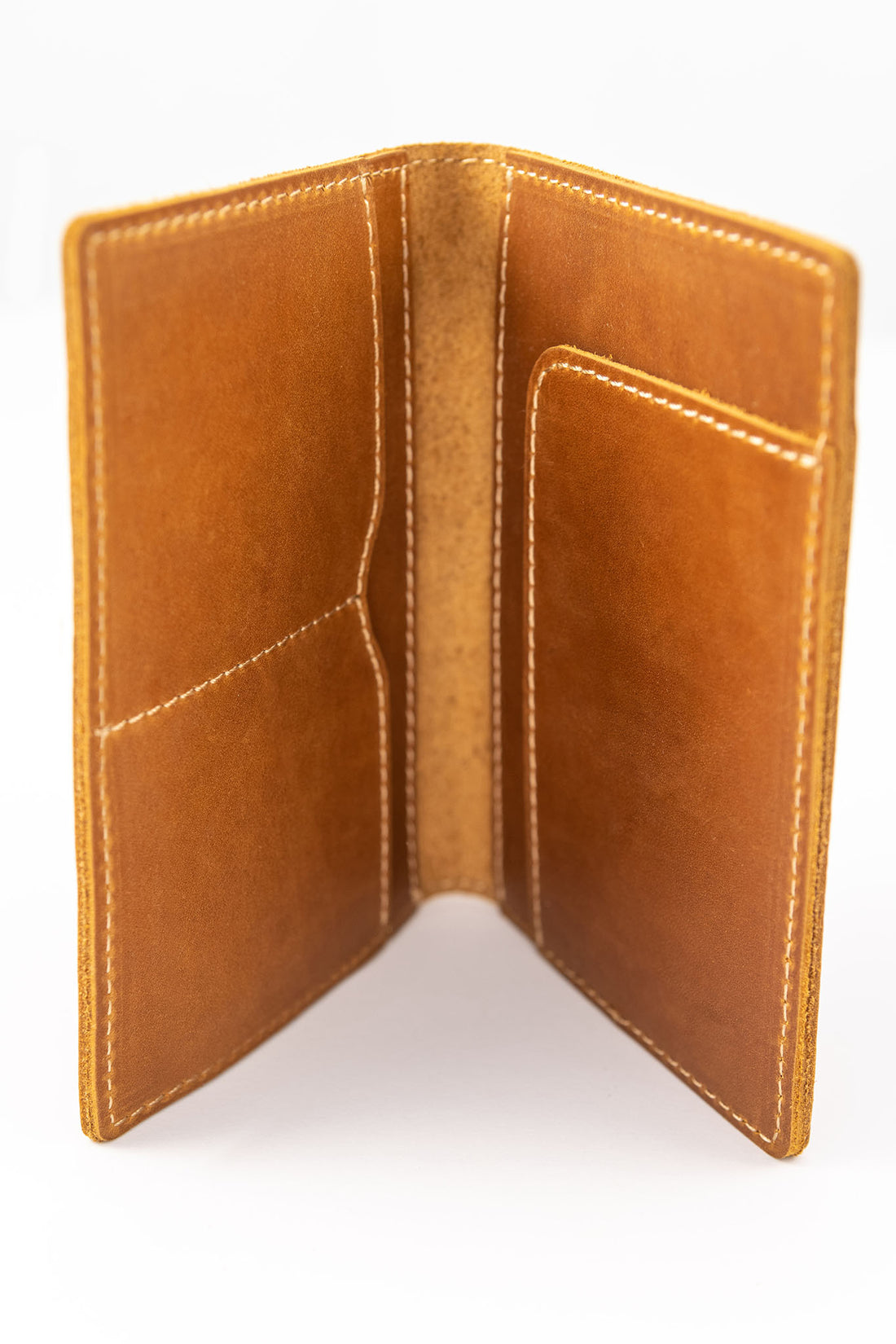 Handmade leather passport wallet made from genuine leather showing internal pockets and tan stitching