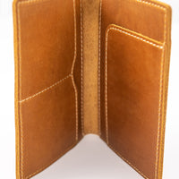 Handmade leather passport wallet made from genuine leather showing internal pockets and tan stitching