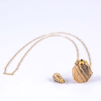 Essential oil necklace made from jasper with a screw top and long gold chain