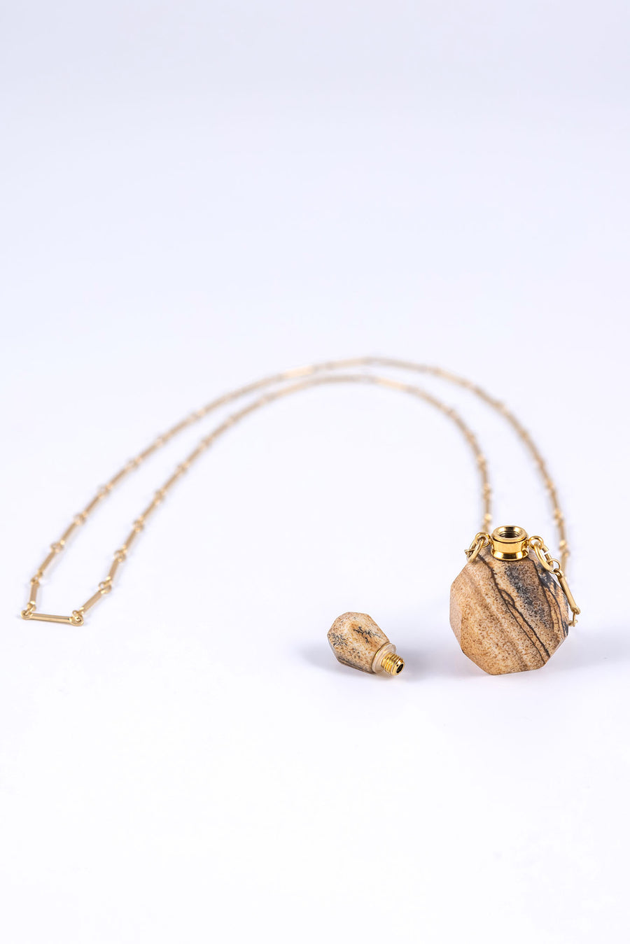 Essential oil necklace made from jasper with a screw top and long gold chain