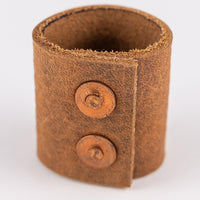 Back view of the leather bandana slide or ring showing two brass snaps that create the closure