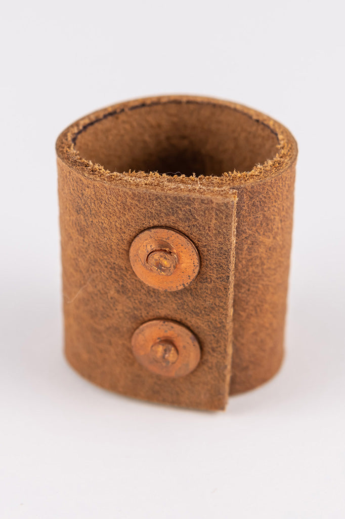 Back view of the leather bandana slide or ring showing two brass snaps that create the closure