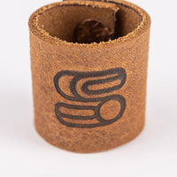 Front view of the brown leather bandana slide with Sound As Ever logo