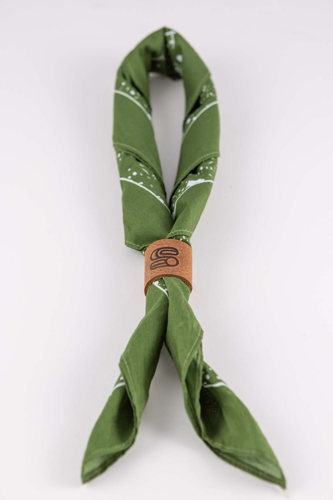 Leather bandana slide in brown genuine leather with stamped Sound As Ever "S" logo that ties closed a green bandana