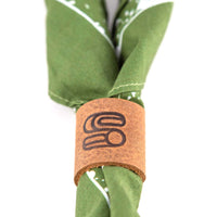 Leather bandana slide with embossed Sound As Ever logo over a green bandana