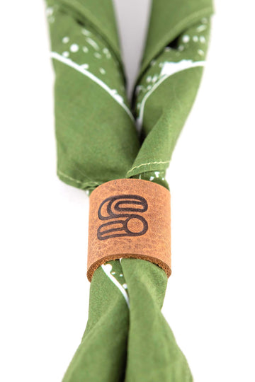 Leather bandana slide with embossed Sound As Ever logo over a green bandana