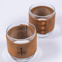 Handmade leather wrapped whiskey glasses with arrow design and brass buttons