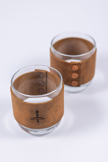Handmade leather wrapped whiskey glasses with arrow design and brass buttons