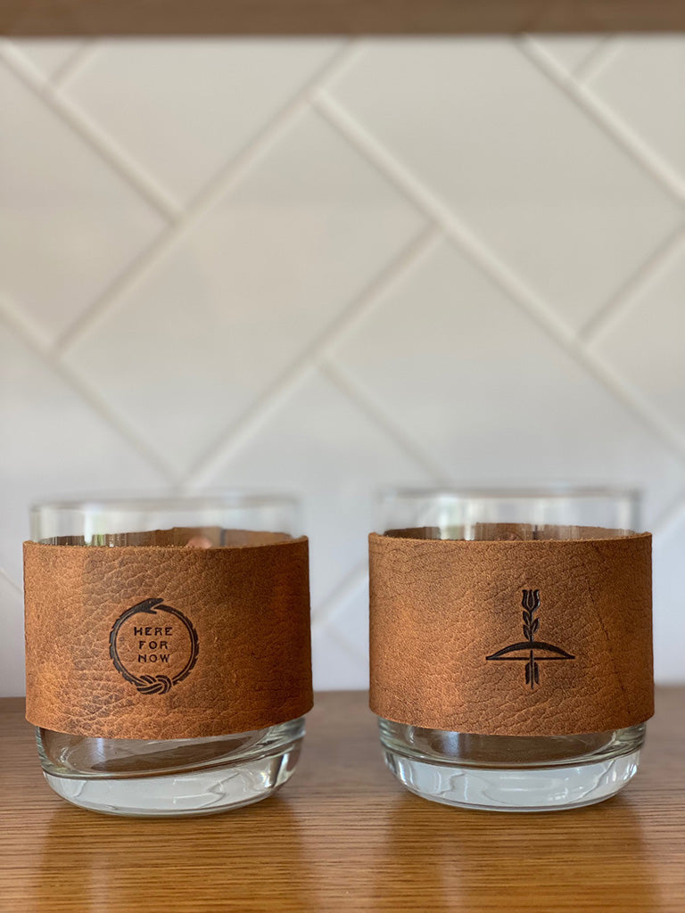 Leather wrapped whiskey glasses with embossing or stamped leather design of Ouroboros "Here For Now" and another with arrow design