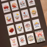 Over twenty National Parks playing cards laid out in a grid showcasing the minimalist colorful illustrations of the parks