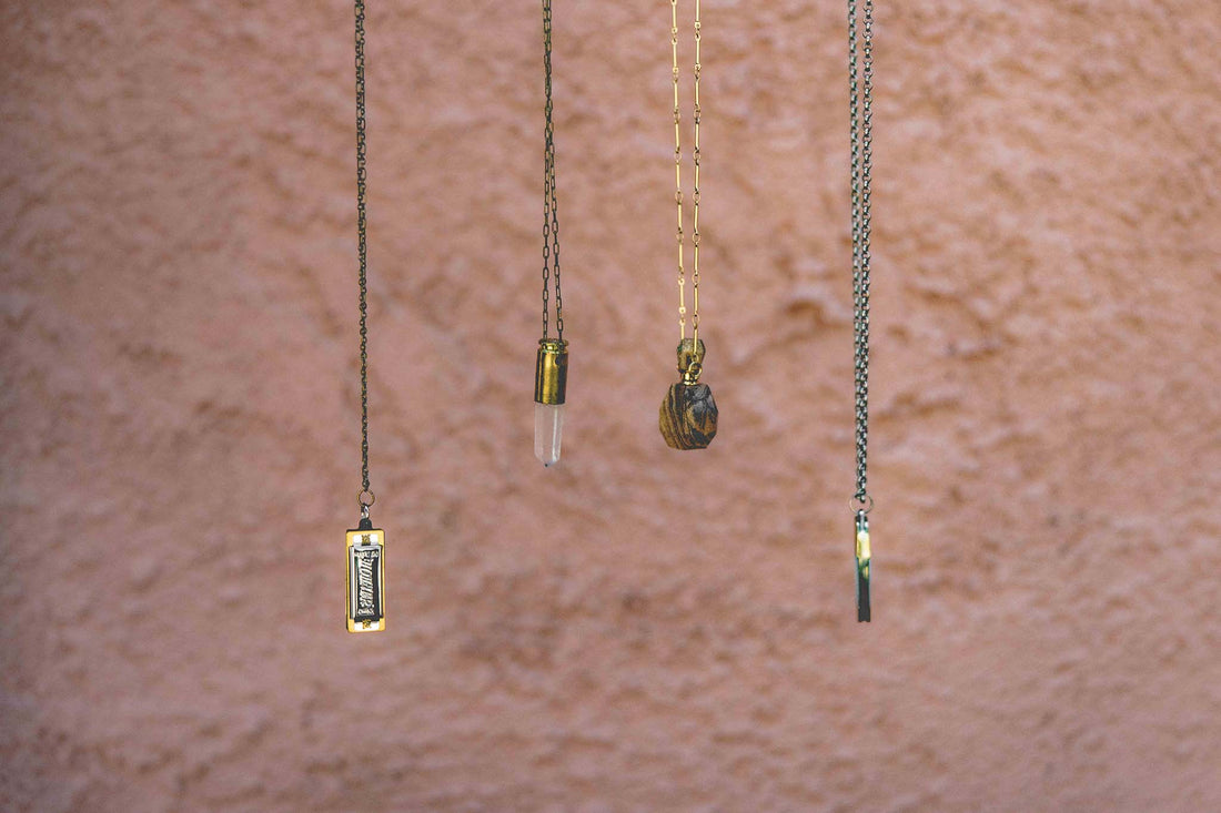 Four Sound as Ever necklaces hanging to display chain and pendants