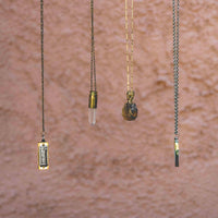 Four Sound as Ever necklaces hanging to display chain and pendants