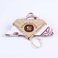 Organic cotton bandana white with red design of the "Sinner Seeker" and folded in a triangle with packaging showing Sound As Ever logo