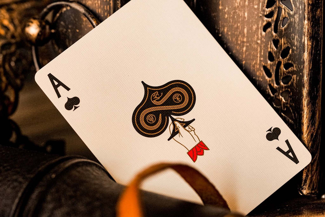 An Ace of spades card- Provision premium playing cards featuring red accents, gold foil, and serpent designs