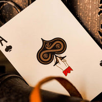 An Ace of spades card- Provision premium playing cards featuring red accents, gold foil, and serpent designs