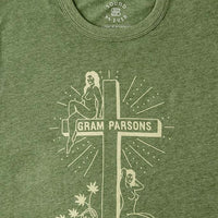 Light green retro graphic tee by Sound As Ever with two women, a cross, and text "Gram Parsons Sinner and Seeker"