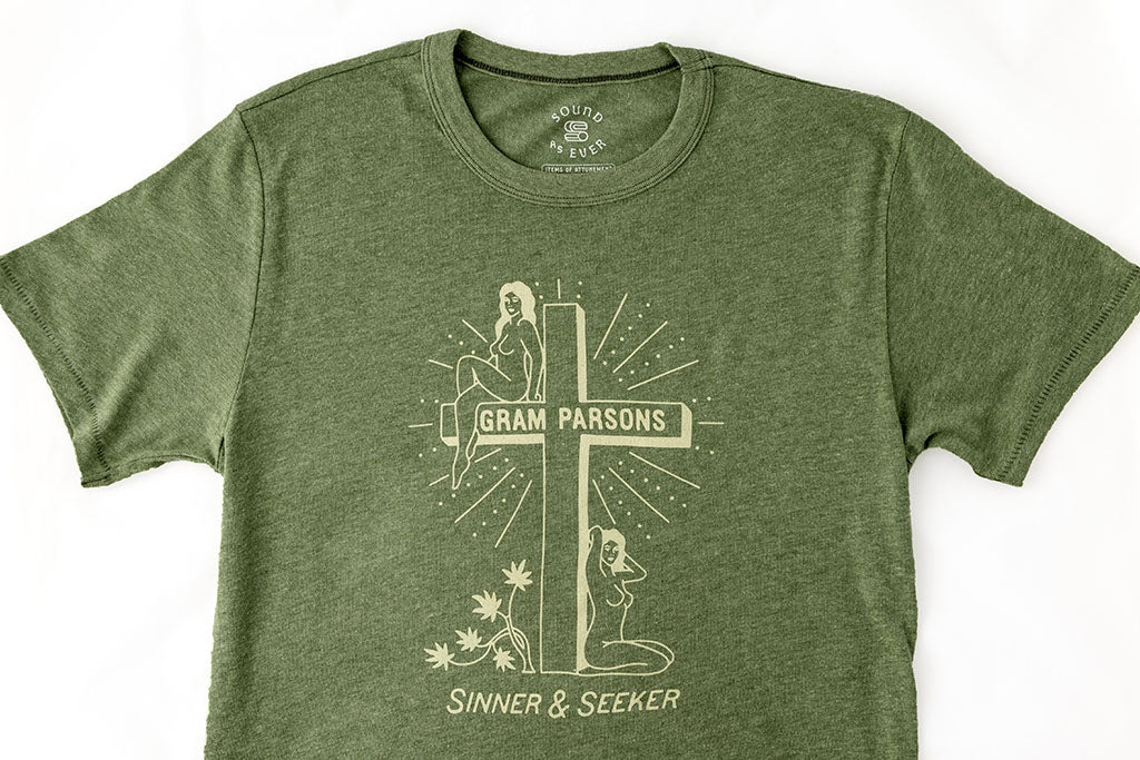 Light green vintage graphic t-shirt by Sound As Ever with two women, a cross, and text "Gram Parsons Sinner and Seeker"