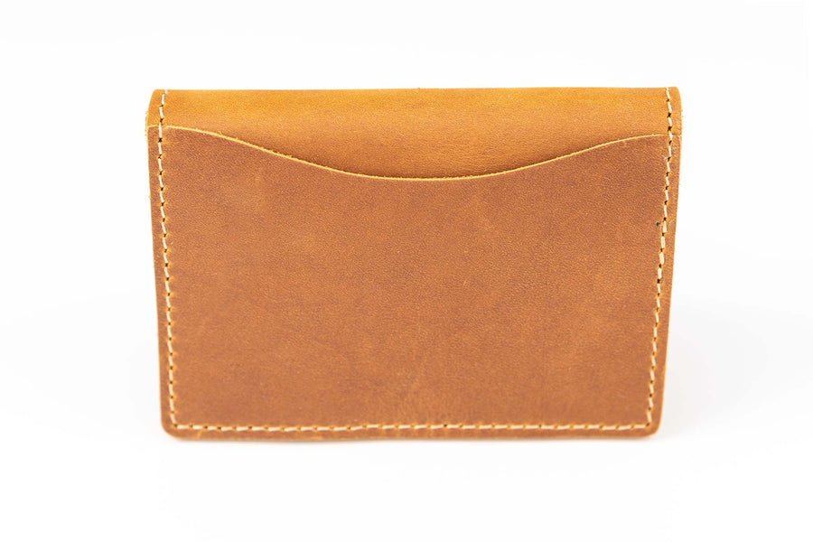 Back of slim bifold leather wallet showing outside quick access pocket