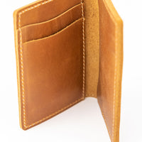 Alternate view of inside pockets of light brown colored slim bifold leather wallet