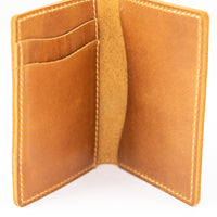 Thin bifold full grain leather wallet open to show card holder and cash pockets