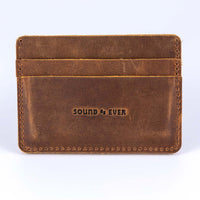 Slim minimalist wallet made from brown genuine leather with two card pockets shown and embossed with text "Sound As Ever"