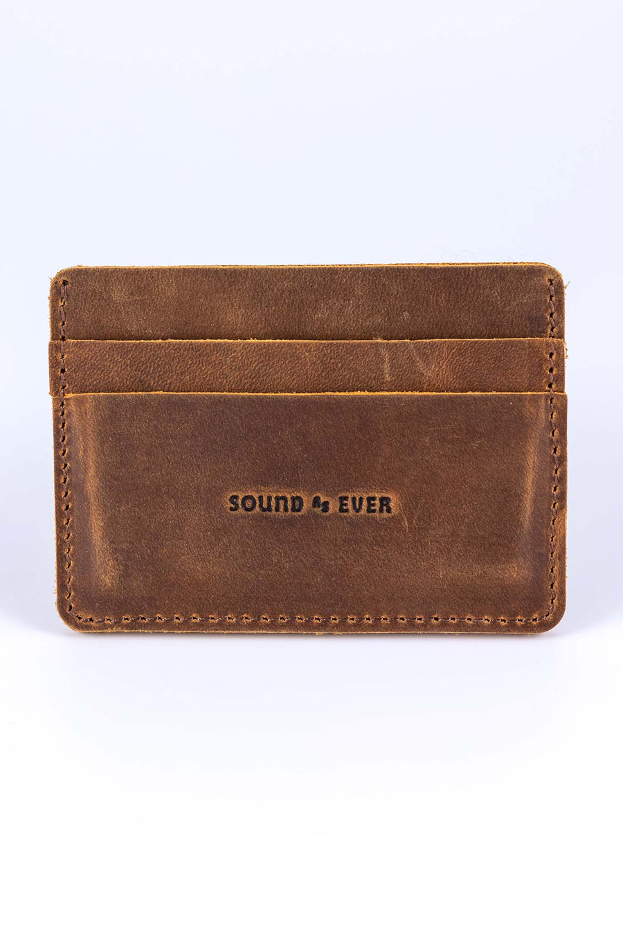 Slim minimalist wallet made from brown genuine leather with two card pockets shown and embossed with text "Sound As Ever"