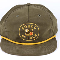 Close up view of Olive green colored Sound As Ever snapback cap featuring yellow embroidered logo