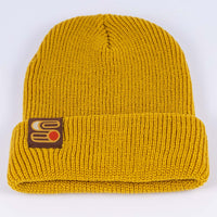 Close up view of yellow Sound As Ever beanie with the Sound as Ever logo on a tag