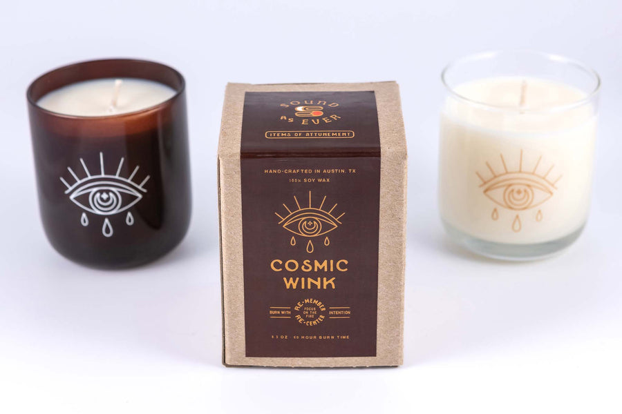 Soy wax candle "Cosmic Wink" scent with design of an eye with tears below it