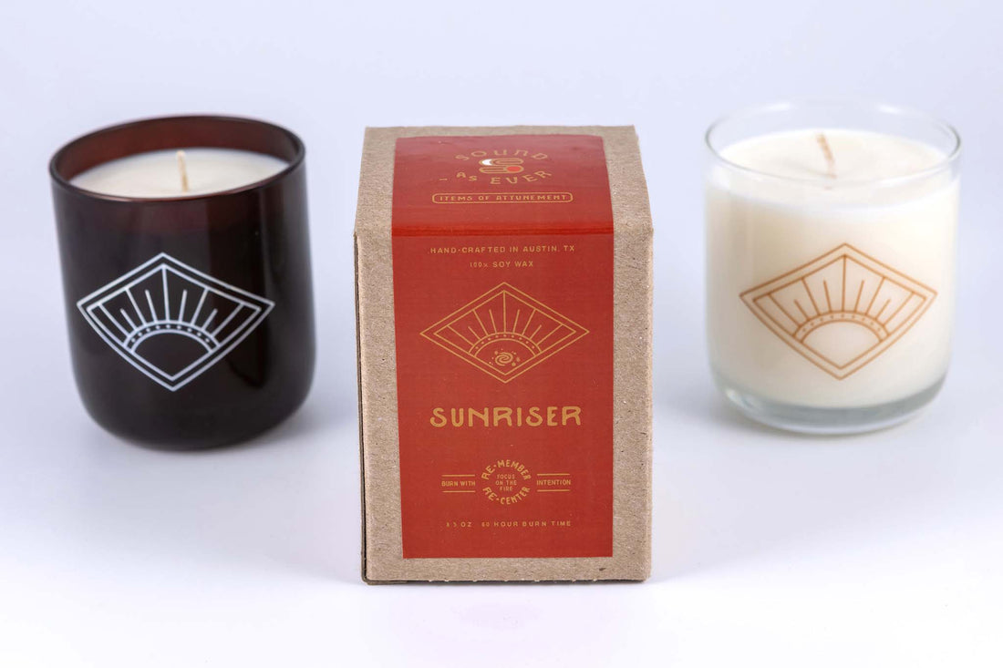 Soy wax candle in "Sunriser" scent with design of diamond with a rising sun inside