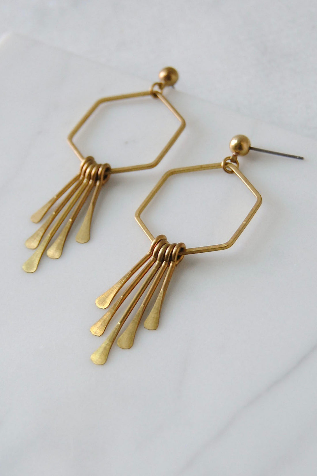 Sunburst earrings made from hammered hexagon loop and hammered brass dangles set on a stud post